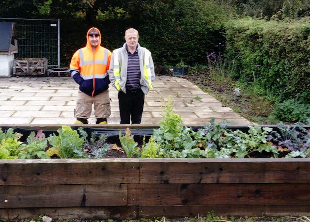 Blooming Brilliant! City & Guilds Success for Clients. 3 Two Pure clients standing by a raised bed of salad they have tended on their City & Guilds in horticulture co