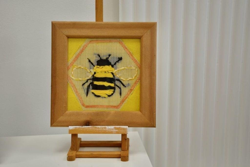 Weaving Magic at Prospect House 1 woven image of a bee in a picture frame at Prospect House