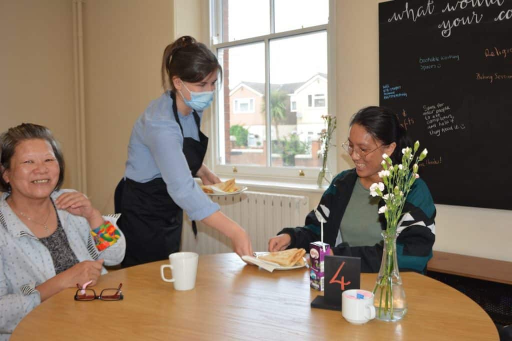Our Social Impact Report is live! 23 Naomi brings a toastie to volunteer Carmen and her mum.