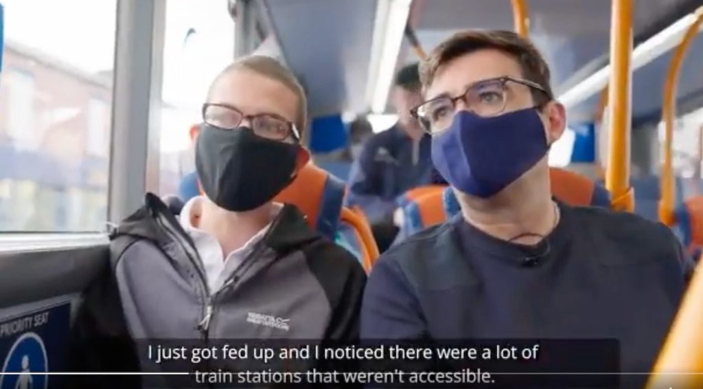 Andy Burnham & Nathaniel on Transport Accessibility 3 Nathaniel and Andy on bus. Captioned "I just got fed up and I noticed there were a lot of train stations that weren't accessible."