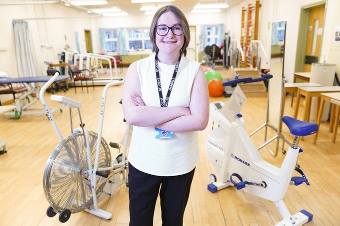 Our Social Impact Report is live! 15 White girl with glasses stood in gym with equipment around her