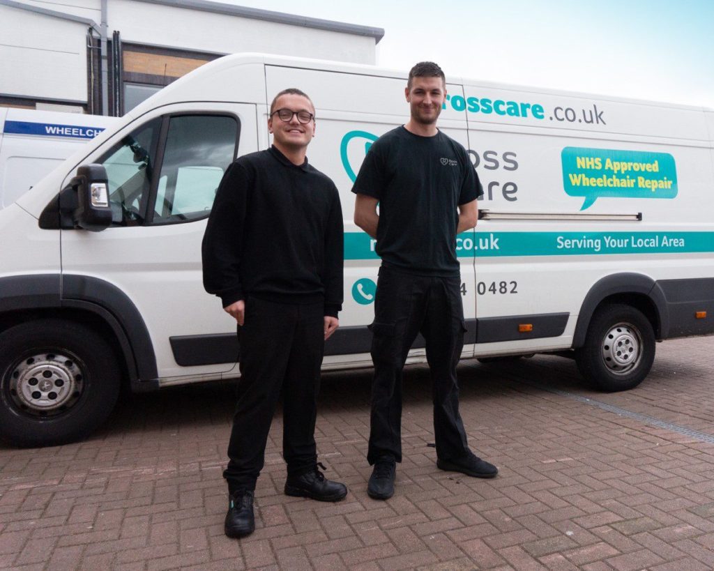 Our Social Impact Report is live! 3 Two men dressed in black clothing standing in front of white van with blue branding