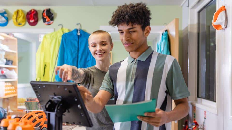 Work experience in a shop looking at computer screen